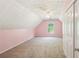 Carpeted bedroom featuring pink walls, ceiling fan, window, and closet at 3880 Dial Mill Ne Rd, Conyers, GA 30013