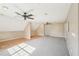 Spacious bonus room featuring two ceiling fans, carpet and wood flooring, and a neutral color palette at 3880 Dial Mill Ne Rd, Conyers, GA 30013