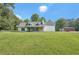 Charming single-Gathering home with a large front yard, stone accents, and a serene, wooded backdrop at 3880 Dial Mill Ne Rd, Conyers, GA 30013