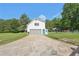 Exterior view showing the front of the home, two-car garage, and extended driveway at 3880 Dial Mill Ne Rd, Conyers, GA 30013