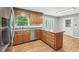 Kitchen includes wood cabinetry, stainless dishwasher and a sunny window at 3880 Dial Mill Ne Rd, Conyers, GA 30013