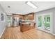 Kitchen with stainless steel appliances, island, and access to the sunroom at 3880 Dial Mill Ne Rd, Conyers, GA 30013