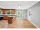 Eat-in kitchen features wood cabinets, stainless steel appliances and sunroom access at 3880 Dial Mill Ne Rd, Conyers, GA 30013