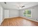 Spacious, bright living room featuring wood floors, a ceiling fan, and ample natural light at 3880 Dial Mill Ne Rd, Conyers, GA 30013