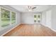 Bright living room with wood floors, ceiling fan, and access to the backyard through glass doors at 3880 Dial Mill Ne Rd, Conyers, GA 30013