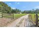 View of a home and surrounding property with gate, fencing, and outbuilding at 3880 Dial Mill Ne Rd, Conyers, GA 30013