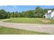 Property featuring a large, well-manicured front yard, driveway and plenty of surrounding trees at 3880 Dial Mill Ne Rd, Conyers, GA 30013