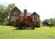 Expansive backyard featuring a wooden deck with stairs, ideal for enjoying the outdoor space at 5665 Stewart Woods Dr, Douglasville, GA 30135