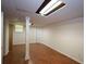 Spacious basement area with exposed ceilings, hardwood floors, and a support beam at 5665 Stewart Woods Dr, Douglasville, GA 30135