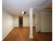 Basement with finished wood flooring and a support beam at 5665 Stewart Woods Dr, Douglasville, GA 30135
