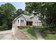 Attractive two-story house with a manicured lawn, complemented by a stone retaining wall and driveway at 5665 Stewart Woods Dr, Douglasville, GA 30135
