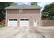 Spacious three-car garage featuring white doors and a convenient side entrance, providing ample parking at 5665 Stewart Woods Dr, Douglasville, GA 30135