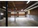 Unfinished garage with concrete floors, exposed piping, and exposed wood beams at 5665 Stewart Woods Dr, Douglasville, GA 30135