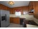 Well-lit kitchen with stainless steel fridge, efficient appliances, and neutral tones for a cozy atmosphere at 5665 Stewart Woods Dr, Douglasville, GA 30135