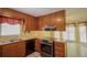 Well-equipped kitchen with wooden cabinets, modern appliances, and a breakfast nook for morning meals at 5665 Stewart Woods Dr, Douglasville, GA 30135