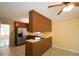 Open kitchen featuring stainless steel appliances, wood cabinetry, and a breakfast bar perfect for casual dining at 5665 Stewart Woods Dr, Douglasville, GA 30135