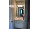 Small bathroom with light fixtures, framed mirror, and neutral tones at 999 Ashebrooke Ne Way, Marietta, GA 30068
