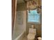 Bathroom with a bathtub and window, accented by neutral walls and towels at 999 Ashebrooke Ne Way, Marietta, GA 30068