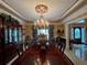 Elegant dining room featuring a chandelier, tray ceiling, and a long wooden table at 999 Ashebrooke Ne Way, Marietta, GA 30068