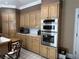 Close up of the kitchen with stainless steel double ovens and wooden cabinetry at 999 Ashebrooke Ne Way, Marietta, GA 30068