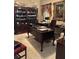 A well-appointed home office with hardwood furnishings, decorations, and large picture frame at 999 Ashebrooke Ne Way, Marietta, GA 30068