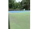 A well-maintained tennis court with vibrant colors and surrounding greenery for active enjoyment at 999 Ashebrooke Ne Way, Marietta, GA 30068