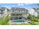 Backyard featuring a large pool, spa, covered deck with seating, and manicured lawn at 107 Owens Mill Place, Canton, GA 30115