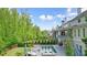 Backyard featuring a pool, deck, and lush landscaping with manicured hedges at 107 Owens Mill Place, Canton, GA 30115