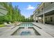 Inviting backyard with a sparkling pool, stone patio, lounge chairs, and manicured landscaping at 107 Owens Mill Place, Canton, GA 30115