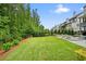 Expansive backyard with lush lawn and lounge chairs beside the pool offers great outdoor space at 107 Owens Mill Place, Canton, GA 30115