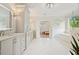 Bright bathroom featuring double vanities, soaking tub, and open doorway at 107 Owens Mill Place, Canton, GA 30115