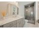 Bright bathroom with white marble countertop, gray vanity and a frameless shower with gray subway tiles at 107 Owens Mill Place, Canton, GA 30115