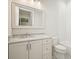 Modern bathroom featuring a vanity with a marble countertop, a large mirror, and a tiled shower at 107 Owens Mill Place, Canton, GA 30115