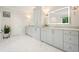 Large bathroom with herringbone floors, gray vanity and garden tub at 107 Owens Mill Place, Canton, GA 30115
