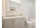 Elegant bathroom featuring a vanity with marble countertop, a large mirror, and a tiled shower/tub at 107 Owens Mill Place, Canton, GA 30115