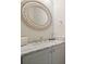 Bathroom vanity with marble countertop, oval mirror, and decorative accents at 107 Owens Mill Place, Canton, GA 30115
