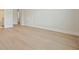 Spacious bedroom featuring hardwood floors and neutral paint; doorway leads to a bathroom at 107 Owens Mill Place, Canton, GA 30115