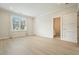Bright, open bedroom featuring hardwood floors, neutral paint, and a large window with blinds at 107 Owens Mill Place, Canton, GA 30115