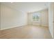 Bright bedroom featuring hardwood floors, neutral paint, window with blinds, and recessed lighting at 107 Owens Mill Place, Canton, GA 30115