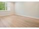 Bright bedroom featuring hardwood floors, neutral paint, and a window with blinds at 107 Owens Mill Place, Canton, GA 30115