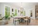 Dining room features a modern table, six chairs, bright natural light, and plantation shutters at 107 Owens Mill Place, Canton, GA 30115