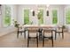 Bright dining room with modern table, chairs, light fixture, plantation shutters and natural light at 107 Owens Mill Place, Canton, GA 30115