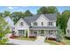 Charming two-story home with gray siding, dark shutters, a welcoming front porch, and beautifully landscaped front yard at 107 Owens Mill Place, Canton, GA 30115