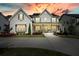 Inviting two-story home with gray siding, dark shutters, and a cozy front porch, perfect for relaxing evenings at 107 Owens Mill Place, Canton, GA 30115