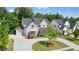 Beautiful two-story home with a circular driveway, attached garage, manicured lawn, and lush landscaping at 107 Owens Mill Place, Canton, GA 30115