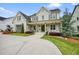 Charming two-story home with gray siding, dark shutters, a welcoming front porch, and well-maintained landscaping at 107 Owens Mill Place, Canton, GA 30115