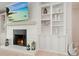 Close up of fireplace with mantle, TV, built-in shelving, and white brick at 107 Owens Mill Place, Canton, GA 30115