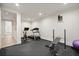 A home gym featuring gym flooring and fitness equipment including a treadmill, weights and a stationary bike at 107 Owens Mill Place, Canton, GA 30115