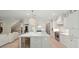 Bright open kitchen featuring a large island, stainless steel appliances, and modern lighting at 107 Owens Mill Place, Canton, GA 30115