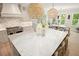 Spacious kitchen with large island and marble countertop with seating and pendant lighting at 107 Owens Mill Place, Canton, GA 30115
